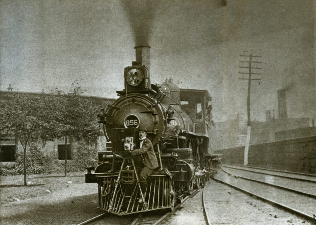 Billy Bitzer strapped to the front of a train filming a 'phantom ride'